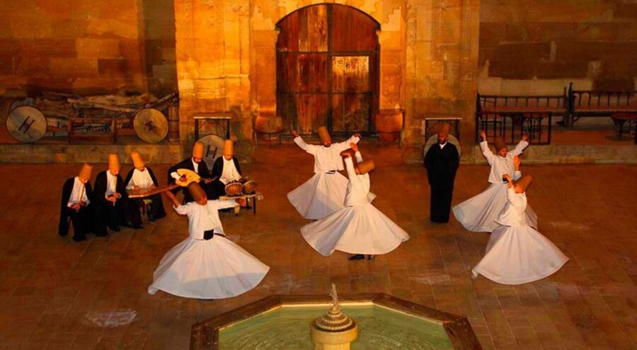 Whirling Dervish Show - The costume symbols: hat, white skirt, and black cloak